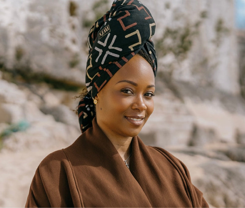 Woman wearing the NVLX Knits mud cloth inspired hair towel